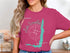 Lake Vermilion Minnesota compass rose and outline graphic on pink t-shirt.