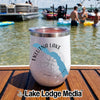 White insulated tumbler with an Eklutna Lake Alaska graphic standing on a wooden boat deck.