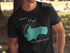 Black t-shirt featuring a teal outline of Walden Pond with "Beautiful Walden Pond Massachusetts" text.