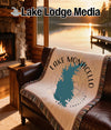 Woven blanket with Lake Monticello map and "South Carolina" text on leather couch.