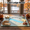A rectangular glass cutting board featuring a blue map of Lake Wenatchee and compass rose design.