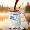 White mug with Lake Cachuma California map and compass graphic, with coffee pouring.