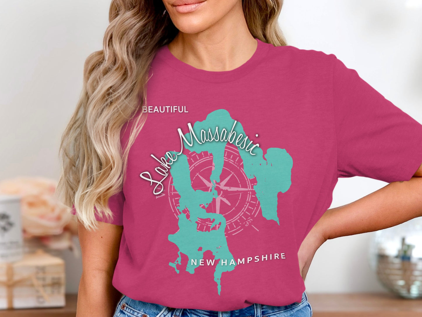 Pink t-shirt featuring a teal outline of Lake Massabesic, New Hampshire.