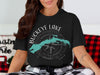 Black t-shirt with "Buckeye Lake Ohio" compass graphic and teal lake outline.
