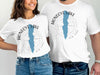 White tees featuring Honeoye Lake map graphic and compass design.