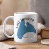 White mug with blue Lake Manawa shape and compass design, reading "LAKE MANAWA IOWA".