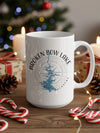White mug with "Broken Bow Lake Oklahoma" and map graphic, surrounded by festive decor.