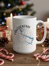 White mug with Lake Sonoma map and compass graphic, with festive holiday decorations.