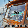 Sticker: Huntington Life with teal state outline on boat window. Lake Lodge Media logo.