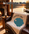 Woven blanket with Crater Lake Oregon map design draped over a leather chair.