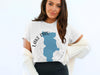 White t-shirt with blue Lake Piru map and compass graphic.