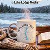 White mug with Aziscohos Lake map and compass on a rainy window view.