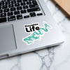 "Douglas Life" sticker with lake map contour on a laptop keyboard.