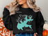 Black sweatshirt with turquoise Parsons Lake map and compass rose.