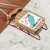 Miniature wooden sled ornament with a turquoise map of Rattlesnake Lake and snowflakes.