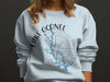 Light blue sweatshirt with Lake Oconee, Georgia, compass design.