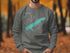Gray sweatshirt with a turquoise map of Sardis Lake and compass.