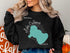 Black sweatshirt with "Beautiful Lake Calhoun Georgia" and compass rose graphic.