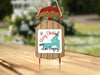Wooden sled ornament with "Merry Christmas from Lake Gregory" text and snowflake design.