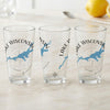 Three clear glasses with "Lake Wisconsin" and map graphics displayed on a marble surface.