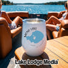 A white wine tumbler with a Mono Lake graphic sits on a wooden boat table.