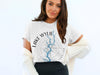 White t-shirt with "Lake Wylie" and "North Carolina" text surrounding a compass and lake graphic.