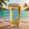 Beer glass with blue Lake Piru map overlay on beach and ocean background.