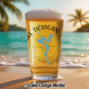 Glass of beer with "Lake Tichigan Wisconsin" map design on a beach.