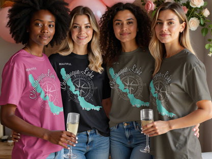 Four women in Chautauqua Lake t-shirts, two holding champagne flutes.