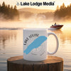 White mug with "Lake Louise" and blue lake outline on a scenic lake background.