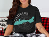 Black t-shirt with teal Geneva Lake Wisconsin graphic and compass design.