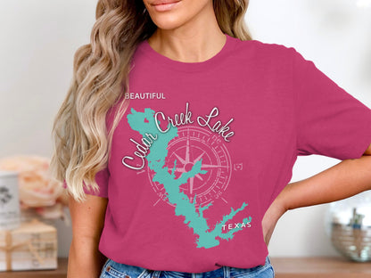 Pink t-shirt featuring a teal outline map of Cedar Creek Lake, Texas.