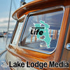 Kissimmee Life sticker on a boat window with Lake Lodge Media logo.
