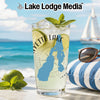 Glass with "Yette Lake" and lake outline design, beach background.