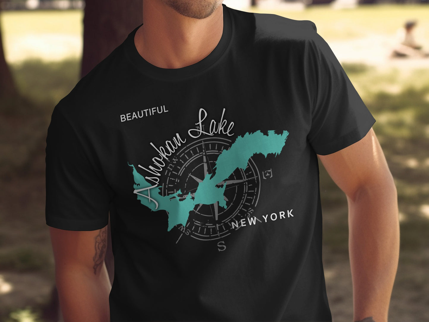 Black t-shirt with turquoise Ashokan Lake map and compass graphic, "New York" text.