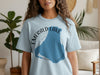 Light blue t-shirt featuring "Emerald Lake Canada" text over a blue lake shape.