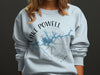 Light blue sweatshirt with "Lake Powell Utah" map graphic and compass rose.