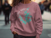 Rose sweatshirt with Lake Martin Alabama compass graphic and text.