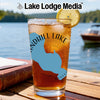 Glass of iced tea with blue lake outline, compass, and "Lake Lodge Media" logo.