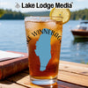 Glass of iced tea with lemon on a wooden table, featuring a blue Lake Winnebago outline.