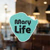 Turquoise sticker with black text "Mary Life" and copyright Lake Lodge Media LLC.