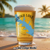 Glass of beer with map of Lake Eufaula, Oklahoma, on a beach.