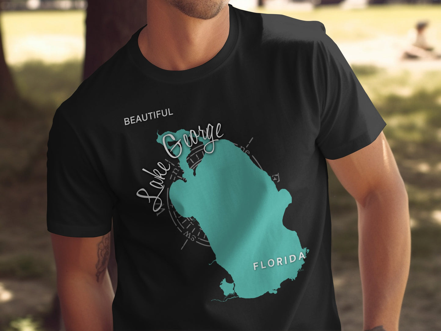 Black t-shirt with "Beautiful Lake George Florida" map graphic.