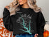 Black sweatshirt with "Beautiful Clarks Hill Lake Georgia" text and compass.