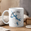 White mug with blue Jordan Lake map graphic and compass design.