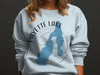 Light blue sweatshirt with Payette Lake Idaho graphic and compass rose.