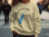 Light tan crewneck sweatshirt with "SARATOGA LAKE NEW YORK" design and compass.