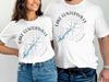 White t-shirts with "Lake Guntersville Alabama" text surrounding a compass and map graphic.