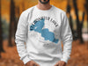White sweatshirt with blue Clearwater Lake map and compass graphic.