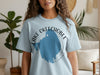 Light blue t-shirt with text "Lake Okeechobee Florida" and blue lake graphic.
